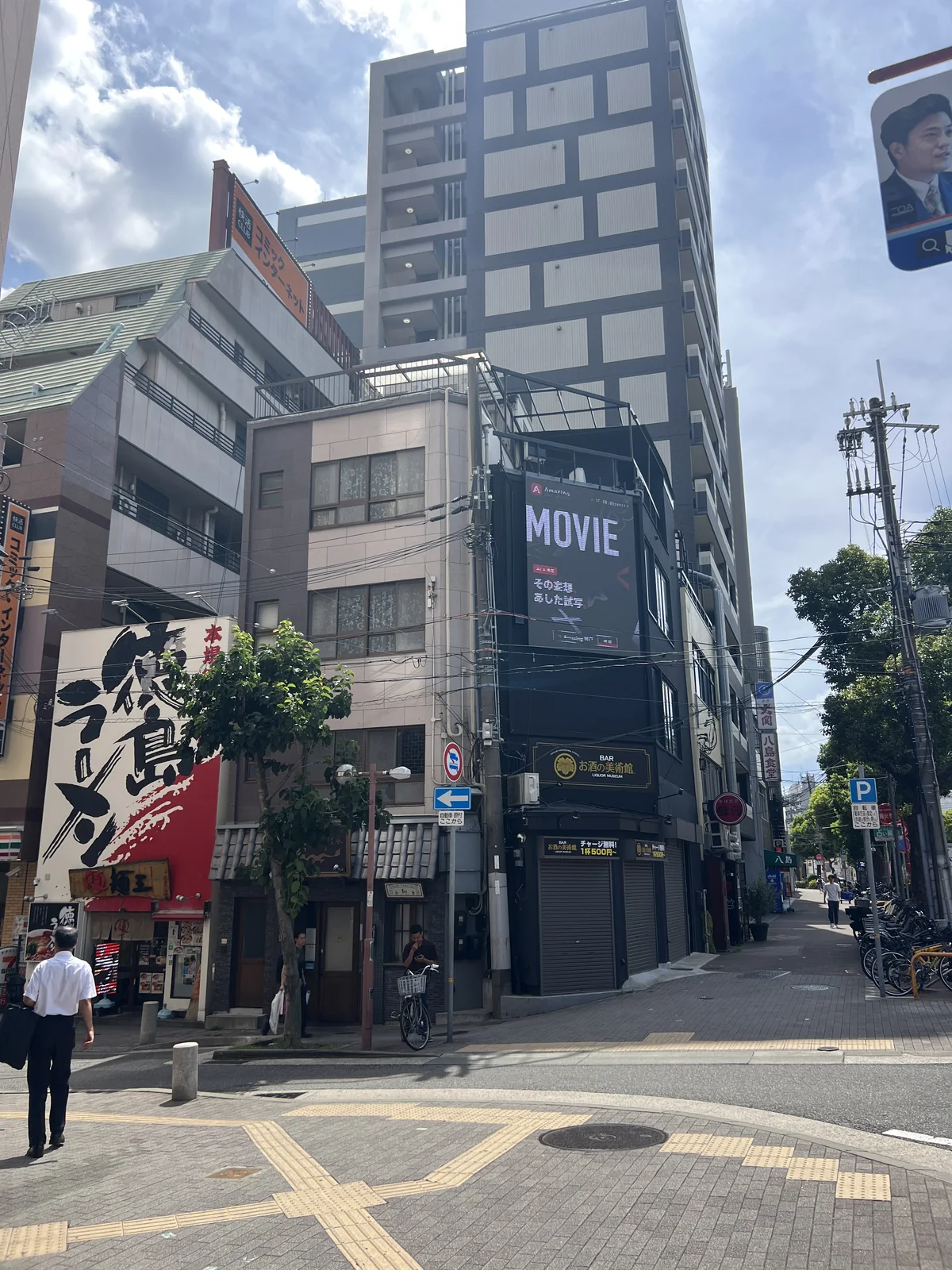 交差点の対角から見た元町の街角。ビル上部のビジョンに「MOVIE」のカットが映っている